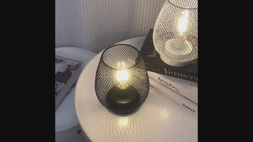 Load video: Retro Iron Art Table Lamp Battery Powered Night Light Hollowed Out Birdcage Desk Reading Lamp Bedroom Decor Bedside Table Lamp Home Decor